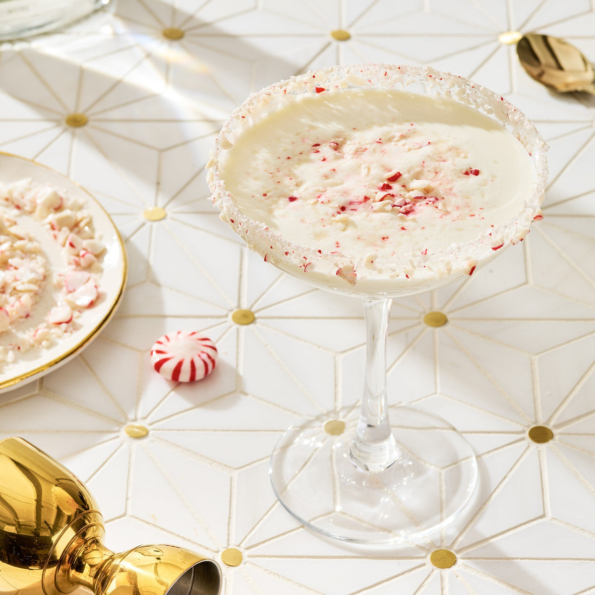 A peppermint martini in a festive/holiday setting table