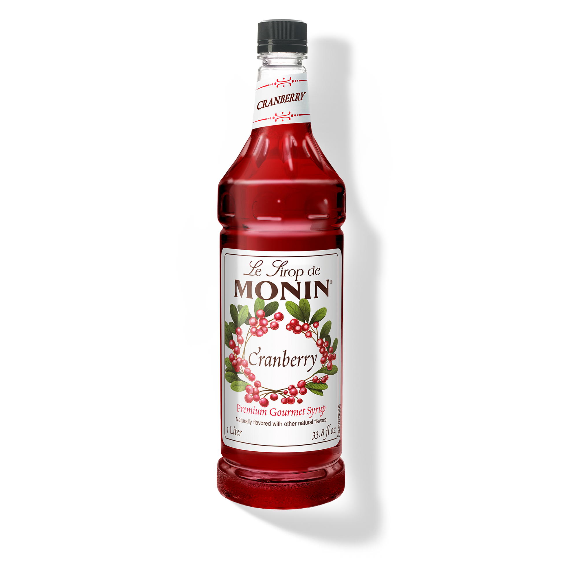 Monin Cranberry syrup bottle on a white background