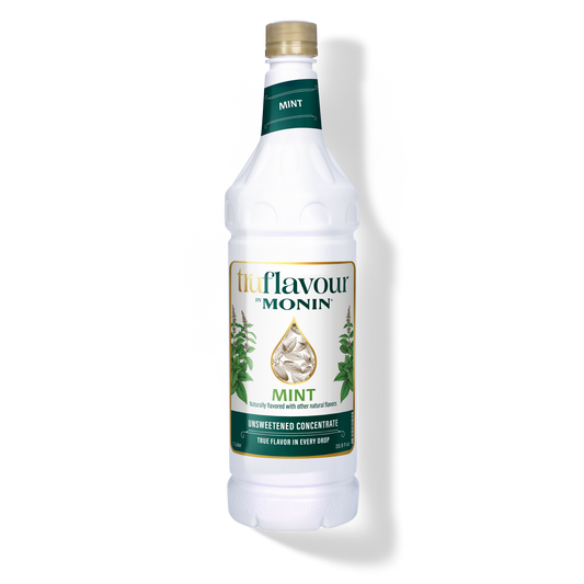 Monin Mint syrup bottle on a white background