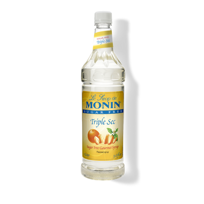 A bottle of Monin Triple Sec sugar-free flavored syrup on a white background with a soft shadow.
