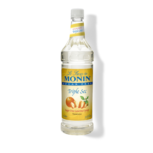 A bottle of Monin Triple Sec sugar-free flavored syrup on a white background with a soft shadow.