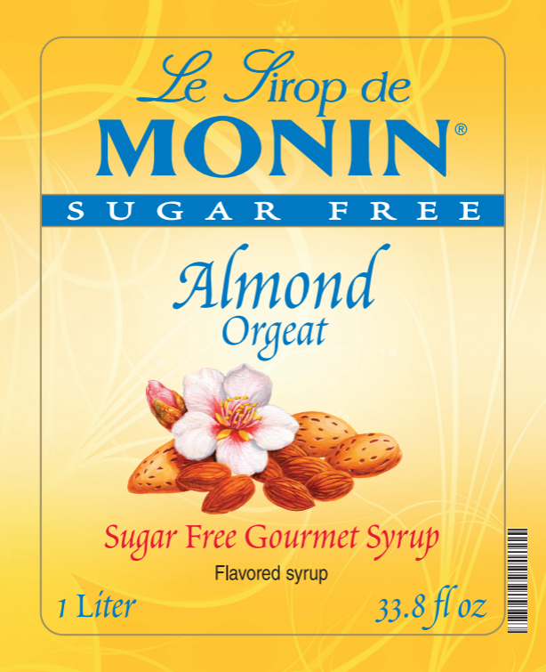 Front of a Le Sirop de Monin Sugar Free Almond Orgeat syrup bottle label, with a yellow background, blue brand text, and an illustration of almonds, a flower, and the words 'Sugar Free Gourmet Syrup' and 'Flavored syrup.'.