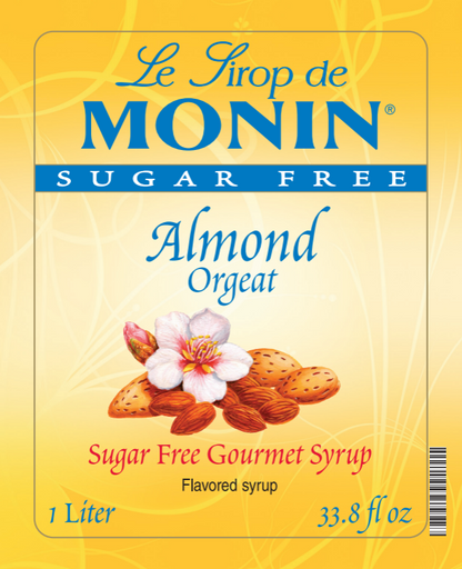 Front of a Le Sirop de Monin Sugar Free Almond Orgeat syrup bottle label, with a yellow background, blue brand text, and an illustration of almonds, a flower, and the words 'Sugar Free Gourmet Syrup' and 'Flavored syrup.'.