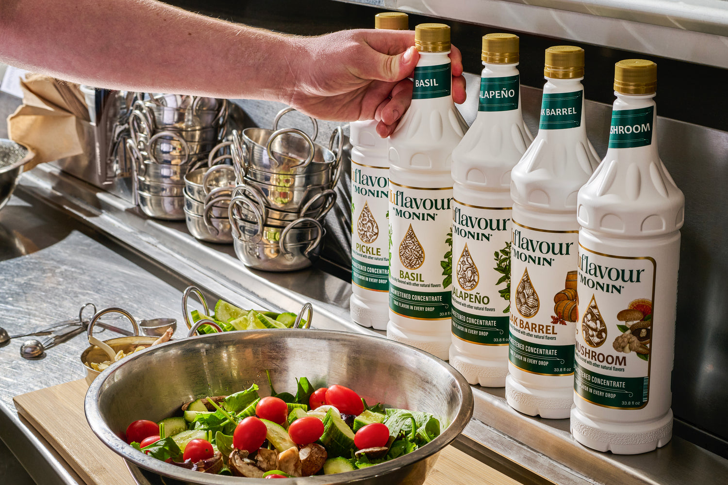 Salad with tomatoes and cucumber in a kitchen with featured monin flavors of pickle, basil, jalapeno, oak barrel and mushroom 