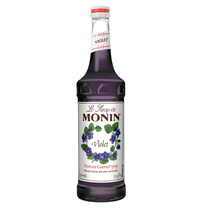 Bottle of Monin Violet syrup on a white background