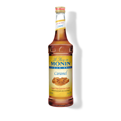 A bottle of Monin Caramel sugar-free syrup on a white background with a soft shadow.