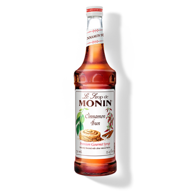 Bottle of Monin Cinnamon Bun syrup on a white background