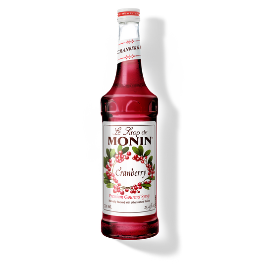 Monin Cranberry syrup bottle on a white background
