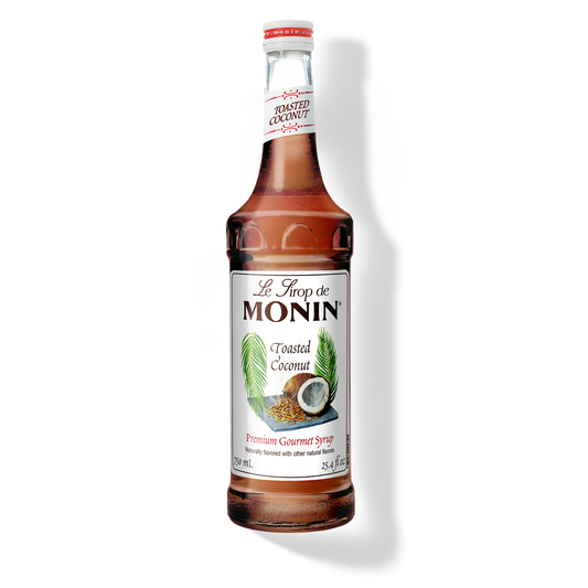 Bottle of Monin Toasted Coconut syrup on a white background