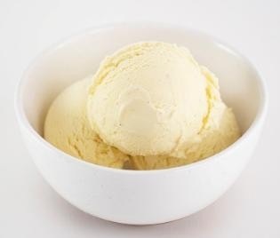 Vanilla ice cream in a white bowl on a light background