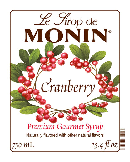 750ML Monin Cranberry syrup label with berries and leaves on a white background