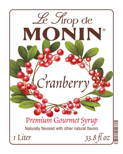 1-Liter Monin Cranberry syrup label with cranberries and leaves on a white background