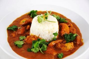 Curry dish with rice on a white plate