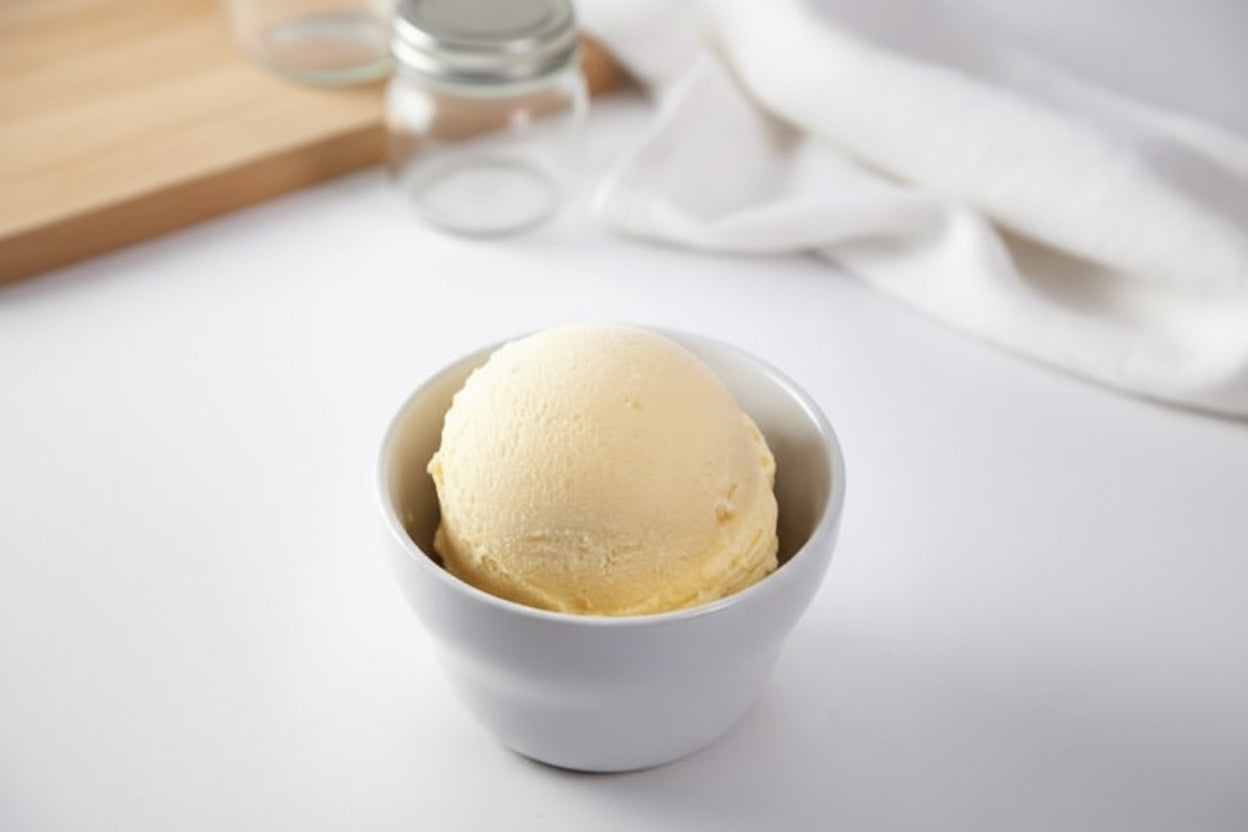 Peanut butter ice cream in a white bowl on a light surface