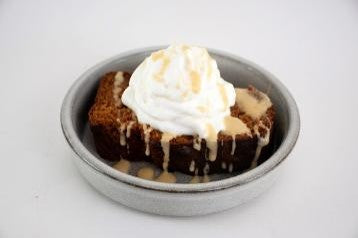 Baked dessert with ice cream in a bowl on a white background