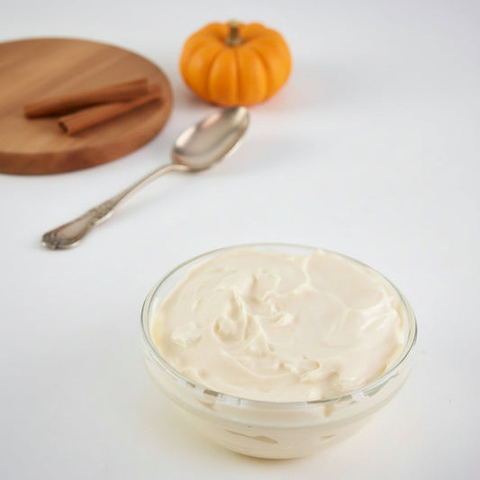 Pumpkin Spice Cream Cheese presented in a small clear glass bowl against a white background.