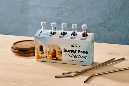 Monin Sugar Free Collection packaging with bottles on a wooden surface