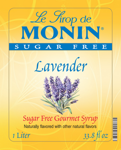 Front of a Le Sirop de Monin Lavender Sugar Free Gourmet Syrup package, showing a yellow label with blue branding, lavender flower illustration, and text indicating 1 Liter / 33.8 fl oz.
