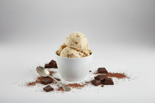 Ice cream scoop in a white bowl on a white background